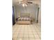 Comfortable main bedroom with tiled flooring, ceiling fan, and neutral paint at 13601 Audrey Ln, Largo, FL 33771
