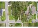 Overhead view showcasing a home's roof, lawn, and driveway in a leafy neighborhood setting at 1402 E Powhatan Ave, Tampa, FL 33604