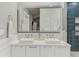 Bright bathroom with double vanity, square sinks, and blue tiled shower at 1402 E Powhatan Ave, Tampa, FL 33604