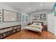 Bright bedroom with hardwood floors, stylish decor, and plenty of natural light at 1402 E Powhatan Ave, Tampa, FL 33604