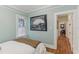 Bedroom featuring hardwood floors, a large window, and tranquil decor at 1402 E Powhatan Ave, Tampa, FL 33604