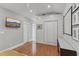 Well-lit bedroom with hardwood floors, a closet and a television at 1402 E Powhatan Ave, Tampa, FL 33604