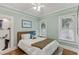 Charming bedroom with hardwood floors, and windows offering natural light at 1402 E Powhatan Ave, Tampa, FL 33604