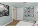 Bright bedroom featuring stylish decor, hardwood floors, and ample natural light at 1402 E Powhatan Ave, Tampa, FL 33604