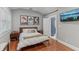 Comfortable bedroom with modern furniture, hard wood floors, with recessed lighting and stylish decor at 1402 E Powhatan Ave, Tampa, FL 33604
