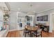 Open dining area with hardwood floors, modern lighting, and convenient access to the kitchen at 1402 E Powhatan Ave, Tampa, FL 33604