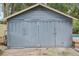 Large detached garage with double doors, situated near a beautiful backyard and patio at 1402 E Powhatan Ave, Tampa, FL 33604