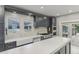 Well-appointed kitchen boasting stainless steel appliances, a white backsplash, and ample cabinet space at 1402 E Powhatan Ave, Tampa, FL 33604
