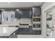 Modern kitchen with grey cabinets, white countertops, stainless steel appliances and beautiful tile backsplash at 1402 E Powhatan Ave, Tampa, FL 33604