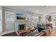 Bright and airy living room with hardwood floors, decorative fireplace, and large windows at 1402 E Powhatan Ave, Tampa, FL 33604