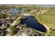 Expansive aerial shot capturing a community encircling a beautiful lake, surrounded by lush greenery at 15104 Azra Dr, Odessa, FL 33556