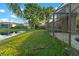 Lush backyard leading to tranquil lake waters, offering stunning natural views and outdoor enjoyment at 15104 Azra Dr, Odessa, FL 33556