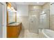 Bathroom featuring vanity with granite countertop, shower, and tub at 15104 Azra Dr, Odessa, FL 33556