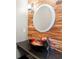 Bathroom features a granite counter, an elegant sink with an exquisite faucet, and wood textured wall at 15104 Azra Dr, Odessa, FL 33556