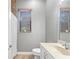 Neutral bathroom featuring a window, light countertops and vanity with a shower to the left at 15104 Azra Dr, Odessa, FL 33556