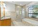 Bathroom featuring a tub, shower, and vanity with granite counter top at 15104 Azra Dr, Odessa, FL 33556