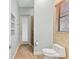 This bathroom features tan tiling, a sink, a window and a shower behind a glass door at 15104 Azra Dr, Odessa, FL 33556