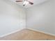 This bedroom features neutral walls and carpet, a ceiling fan and a door leading to another room at 15104 Azra Dr, Odessa, FL 33556