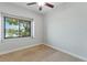 This carpeted bedroom boasts a water view from the window at 15104 Azra Dr, Odessa, FL 33556