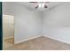 Bedroom has a closet with shelving and a door to the hallway, and a window with a ceiling fan at 15104 Azra Dr, Odessa, FL 33556