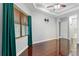 Bedroom with hardwood floors, ceiling fan, and natural light from a large window at 15104 Azra Dr, Odessa, FL 33556