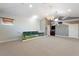 Large bonus room featuring a chandelier, ceiling fan, and a golf course-themed decorative railing at 15104 Azra Dr, Odessa, FL 33556