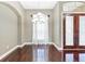 Dining area with gleaming hardwood floors and elegant lighting fixtures near glass entry doors at 15104 Azra Dr, Odessa, FL 33556