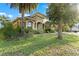 Lush landscaping surrounds this charming home with mature trees and a paver driveway at 15104 Azra Dr, Odessa, FL 33556