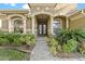 Charming front entrance with stone walkway, manicured landscaping, and covered entryway at 15104 Azra Dr, Odessa, FL 33556