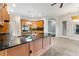 Kitchen with breakfast bar, granite countertops, stainless appliances, and wood cabinets at 15104 Azra Dr, Odessa, FL 33556