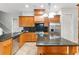 Modern kitchen featuring granite counters, stainless steel appliances, and a functional center island at 15104 Azra Dr, Odessa, FL 33556