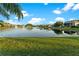 Lush greenery frames a picturesque lake view with a fountain, offering an idyllic backdrop for community at 15104 Azra Dr, Odessa, FL 33556
