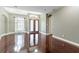 Bright and airy living area with beautiful wood floors and stylish, modern light fixtures at 15104 Azra Dr, Odessa, FL 33556