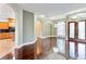 Spacious living room features gleaming wood floors, elegant lighting, and direct access to kitchen at 15104 Azra Dr, Odessa, FL 33556