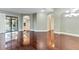 Open living area features hardwood flooring, arched doorways, and sliding glass doors at 15104 Azra Dr, Odessa, FL 33556