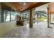 Well-equipped outdoor kitchen and living space adjacent to a pool and serene lake view at 15104 Azra Dr, Odessa, FL 33556