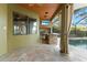 Outdoor kitchen with a grill and sink, perfect for entertaining with a pool and waterfront backdrop at 15104 Azra Dr, Odessa, FL 33556