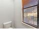 Toilet room featuring toilet and window at 15104 Azra Dr, Odessa, FL 33556