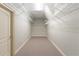 A long walk-in closet with wire shelving and carpeted floor, offering ample storage space at 15104 Azra Dr, Odessa, FL 33556