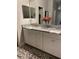 Bathroom featuring a double vanity with granite countertops and white cabinets at 1600 Still River Dr, Venice, FL 34293