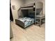 This bedroom features laminate floors, a bunk bed with stairs, a desk, and soft neutral colors at 1600 Still River Dr, Venice, FL 34293