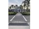 Inviting clubhouse with palm trees and lush landscaping, perfect for community gatherings at 1600 Still River Dr, Venice, FL 34293