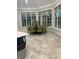 Bright dining area with large windows, elegant chairs, and stylish floors at 1600 Still River Dr, Venice, FL 34293