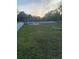 Spacious community dog park with fencing, seating, and mature trees providing ample shade at 1600 Still River Dr, Venice, FL 34293