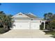 Charming home featuring a two-car garage, landscaped yard, and a well-maintained exterior at 1600 Still River Dr, Venice, FL 34293