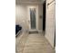 Well-lit foyer with a sliding barn door and a white railing, showcasing the home's entrance at 1600 Still River Dr, Venice, FL 34293