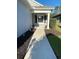 Inviting front porch area with a manicured lawn and walkway leading to the front door at 1600 Still River Dr, Venice, FL 34293