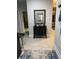 Stylish hallway featuring a modern light fixture and a decorative table against a neutral wall at 1600 Still River Dr, Venice, FL 34293