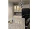 Modern kitchen featuring granite countertops, custom cabinetry, a stylish light fixture, and stainless steel appliances at 1600 Still River Dr, Venice, FL 34293