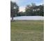 A well-maintained sand volleyball court with a net is surrounded by lush greenery and a grassy area at 1600 Still River Dr, Venice, FL 34293